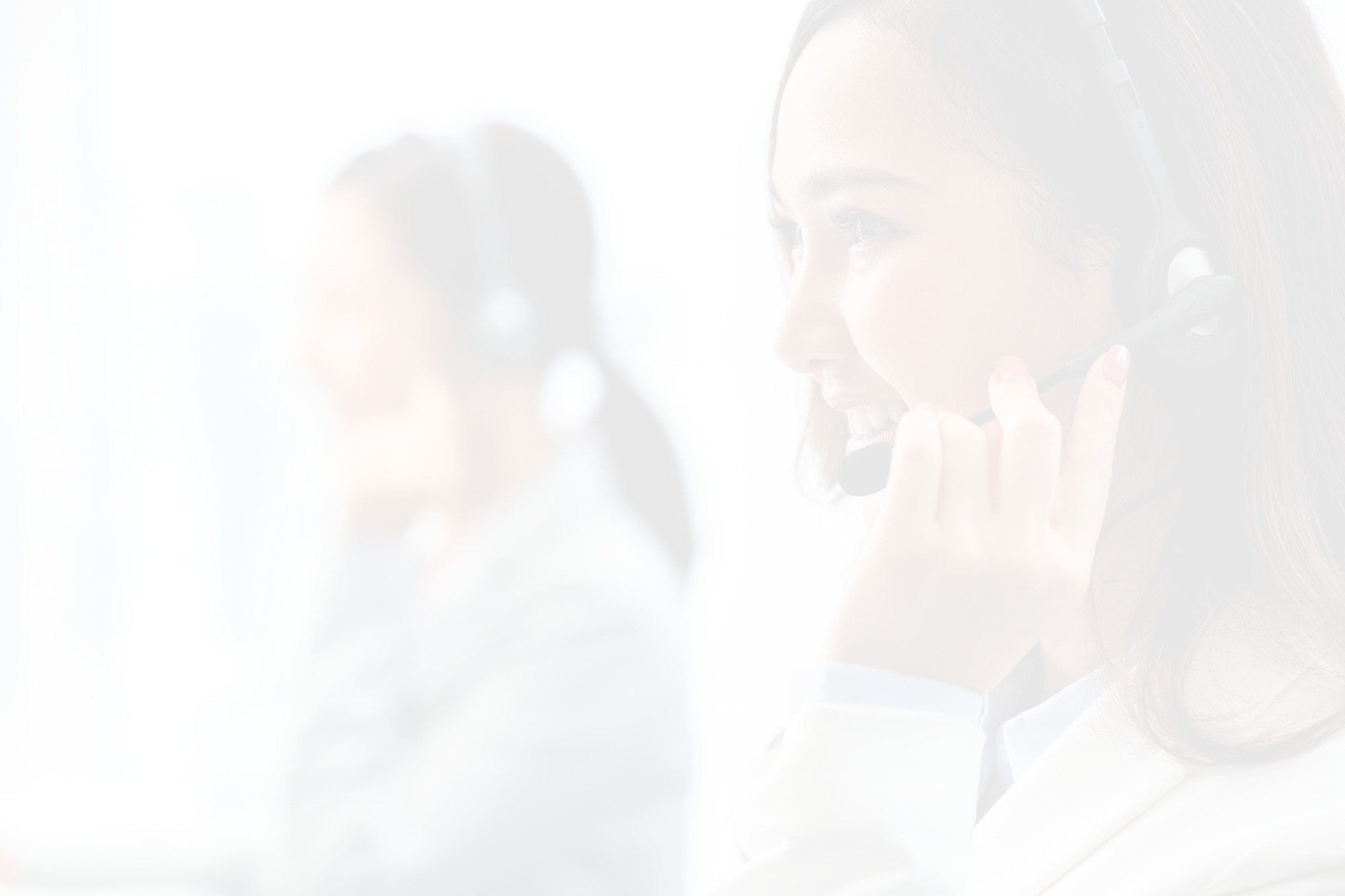 Smiling woman wearing headset working in call center office